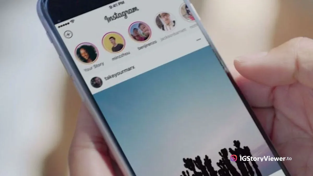 A person holding a phone showing the Instagram home feed, with the Stories row of circular avatars along the top